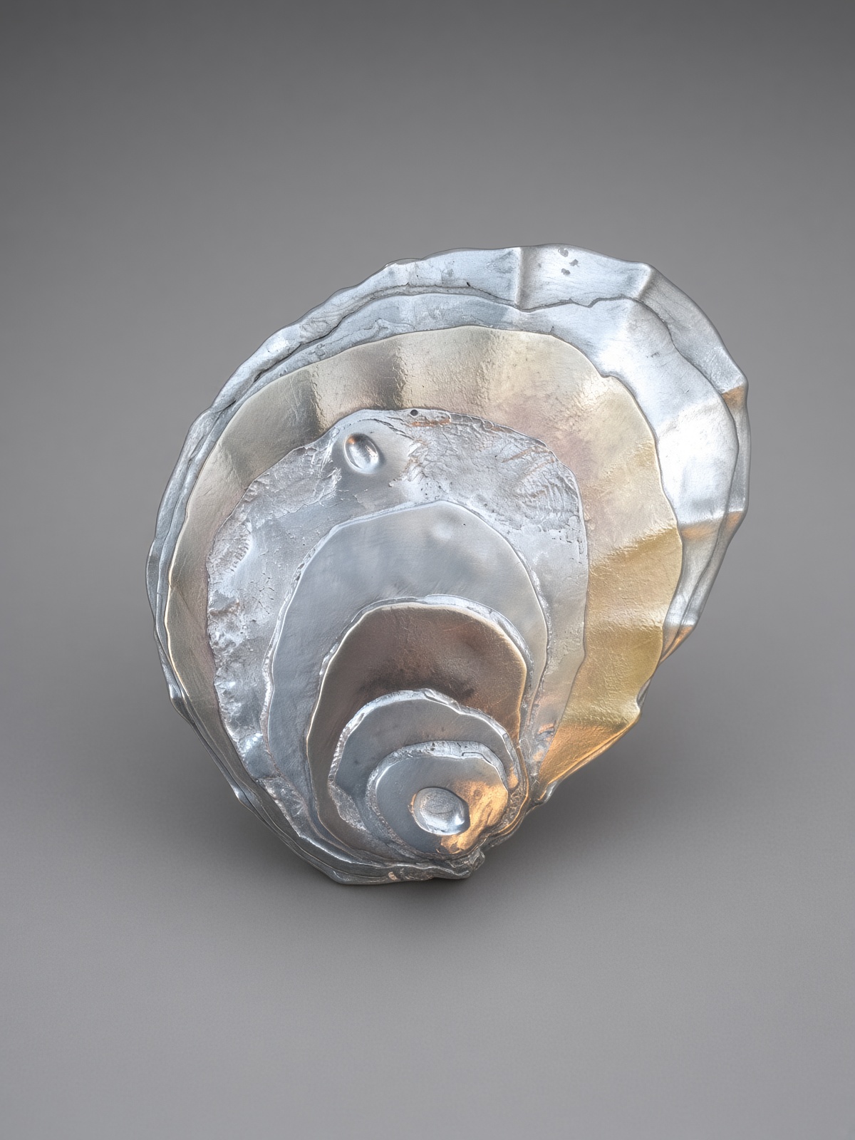 Forged topography. A spiral of raised metal ridges.